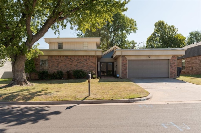 ranch-style house featuring a garage and a front lawn