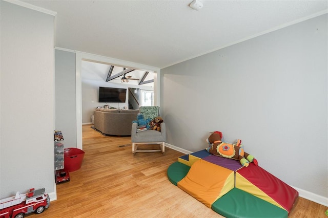 rec room featuring ornamental molding, hardwood / wood-style floors, and ceiling fan