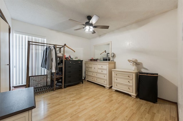 interior space with ceiling fan, light hardwood / wood-style floors, and a textured ceiling