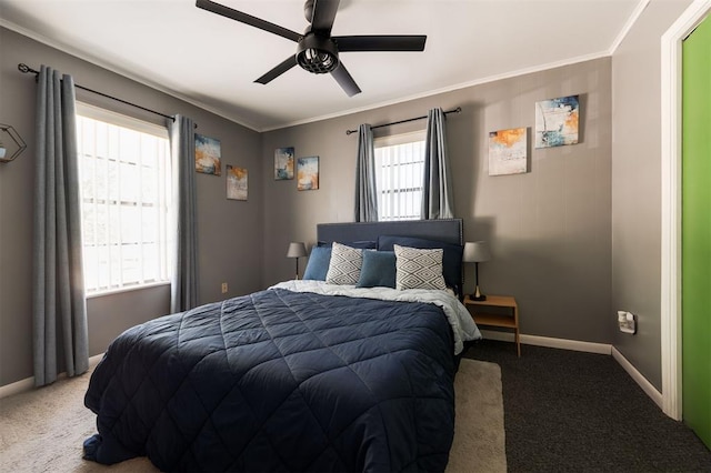 carpeted bedroom with ceiling fan and ornamental molding