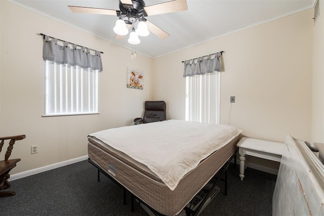 carpeted bedroom with ceiling fan and ornamental molding