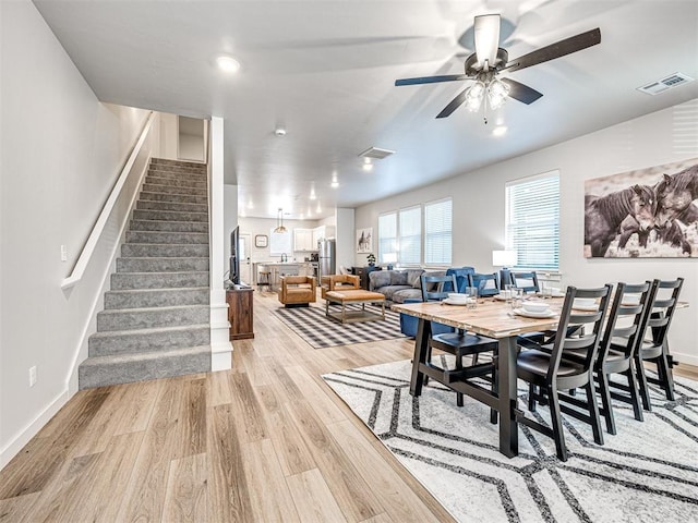 dining area featuring ceiling fan and light wood-type flooring