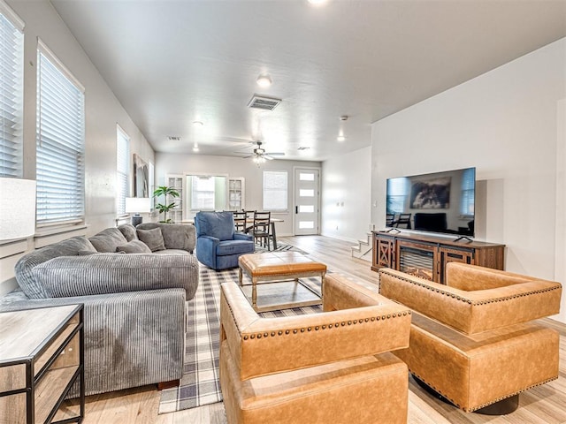 living room with ceiling fan and light hardwood / wood-style floors