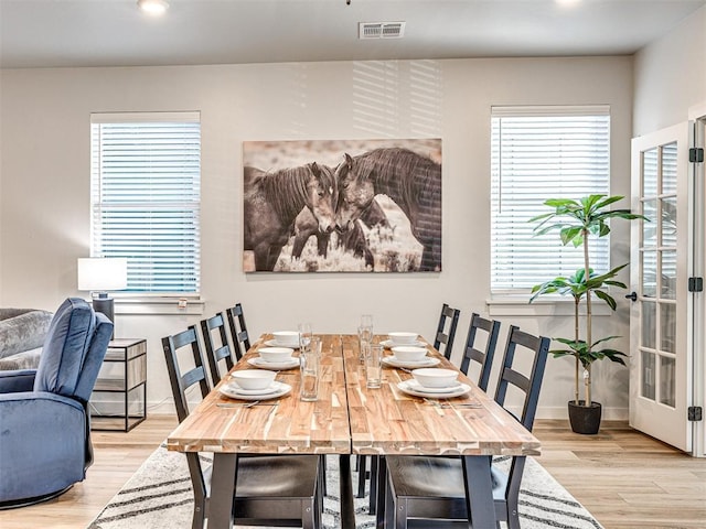 dining space with light hardwood / wood-style floors