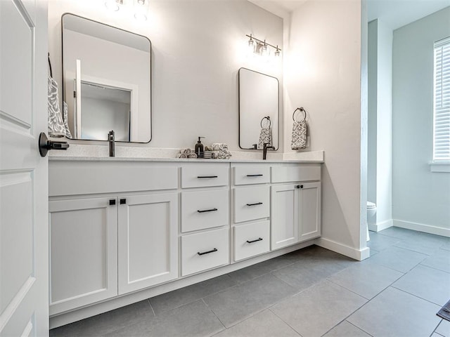 bathroom with vanity, toilet, and tile patterned flooring