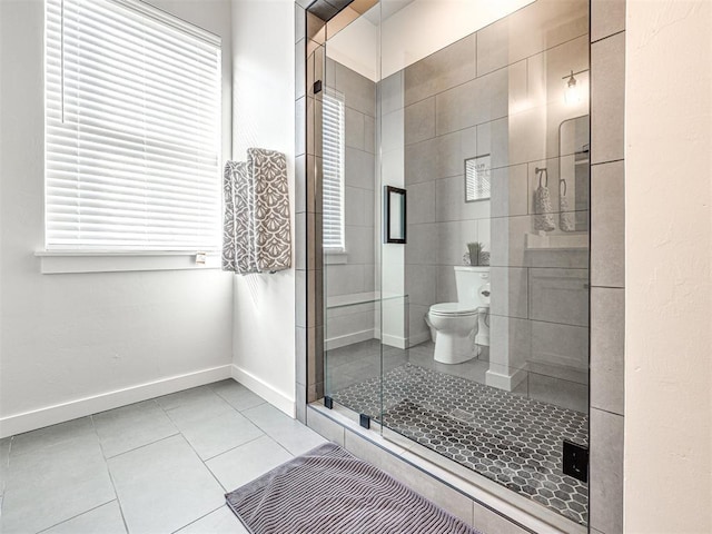 bathroom featuring tile patterned flooring, an enclosed shower, and toilet