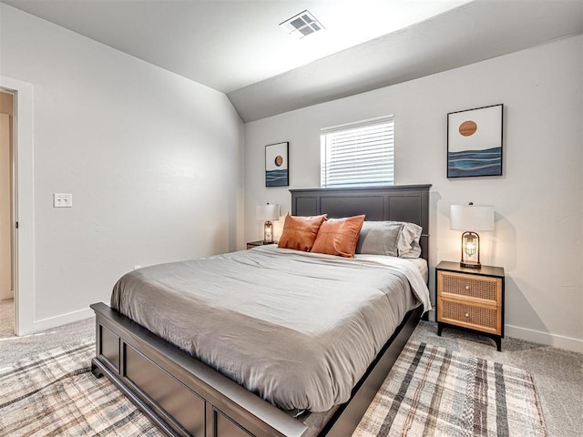 bedroom featuring vaulted ceiling and carpet