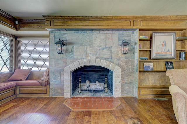 interior details with hardwood / wood-style flooring and a fireplace