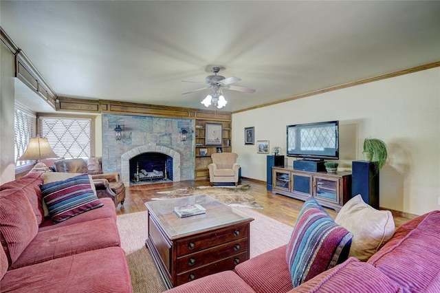 living room with ceiling fan, ornamental molding, and light hardwood / wood-style flooring