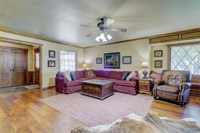 living room with hardwood / wood-style flooring, ornamental molding, and ceiling fan