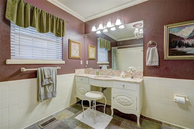 bathroom with ornamental molding, a shower with shower curtain, tile walls, and vanity