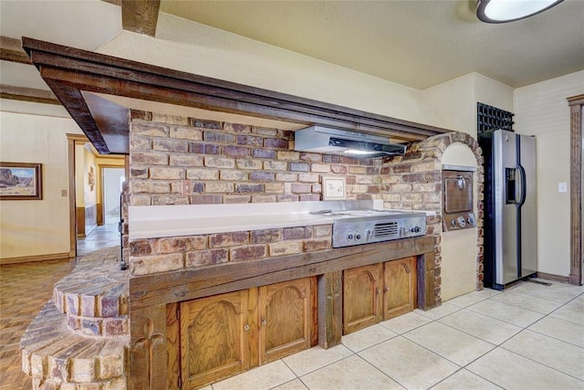 kitchen featuring appliances with stainless steel finishes, extractor fan, and light tile patterned floors