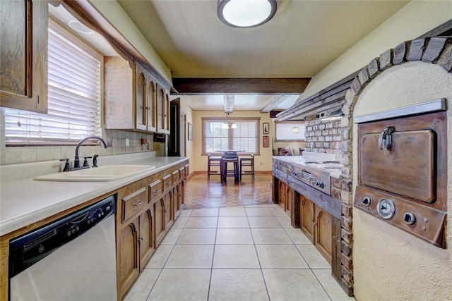 kitchen featuring sink, light tile patterned floors, stainless steel dishwasher, beamed ceiling, and backsplash