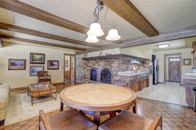 dining space with beamed ceiling and light parquet floors