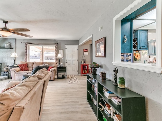 living room featuring light hardwood / wood-style flooring and ceiling fan