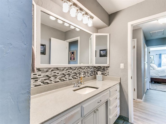 bathroom featuring tasteful backsplash, vanity, and hardwood / wood-style flooring