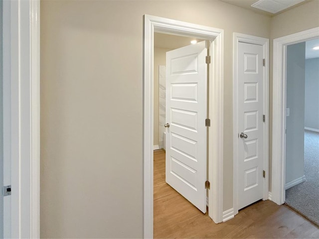 corridor with light hardwood / wood-style floors