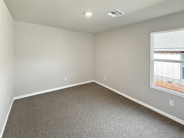 empty room with dark carpet