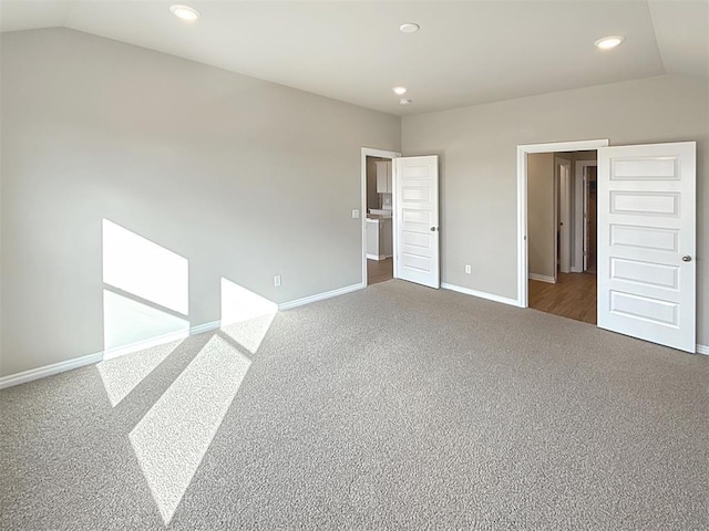 unfurnished bedroom with lofted ceiling and carpet flooring