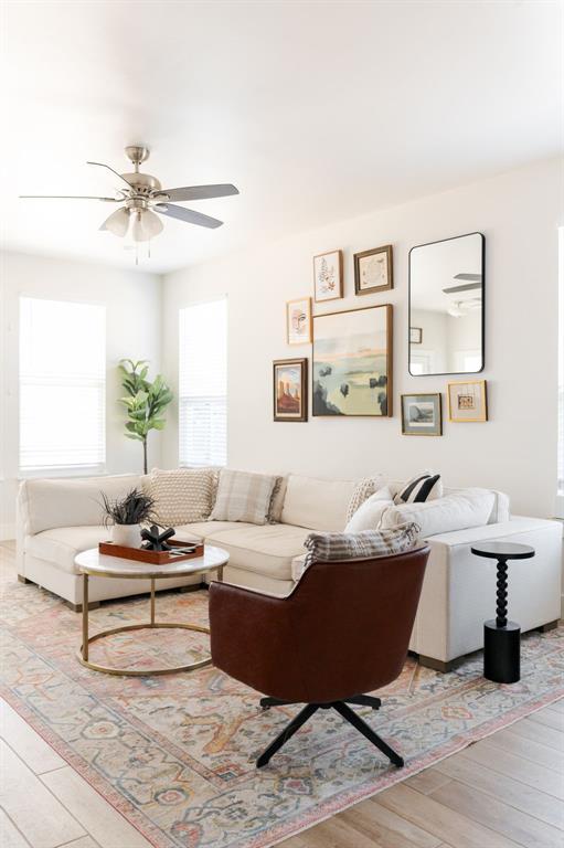 living room featuring ceiling fan and light wood-type flooring