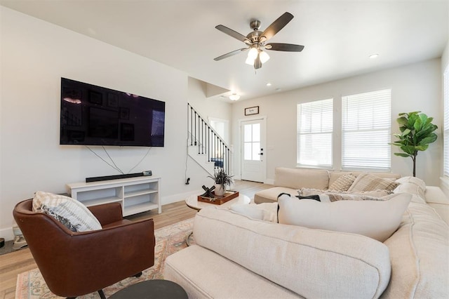 living room with ceiling fan and light hardwood / wood-style floors