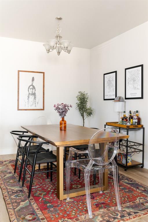 dining area featuring an inviting chandelier and hardwood / wood-style floors