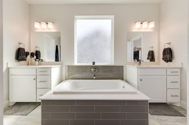 bathroom with vanity and tiled bath