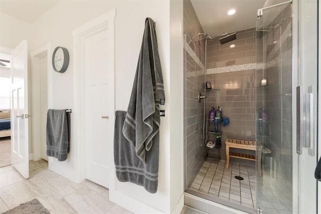 bathroom featuring a shower with shower door