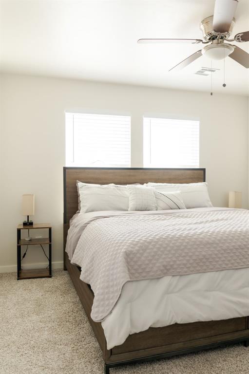 bedroom featuring ceiling fan and light colored carpet