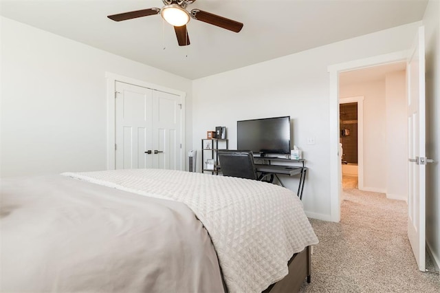 carpeted bedroom with ceiling fan and a closet