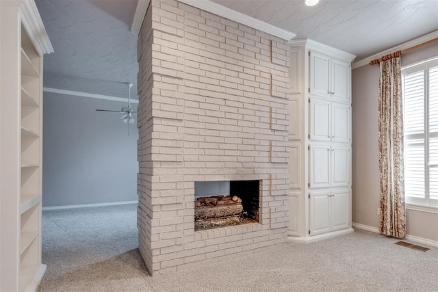 unfurnished living room featuring ceiling fan, ornamental molding, a fireplace, and light carpet