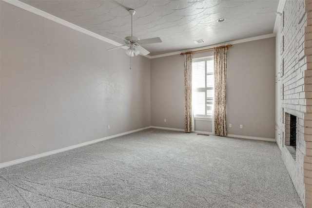 unfurnished living room featuring a textured ceiling, ornamental molding, carpet floors, ceiling fan, and a fireplace