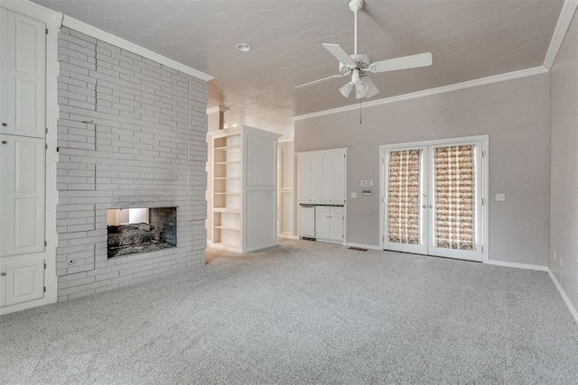 unfurnished living room with ornamental molding, carpet flooring, and a brick fireplace