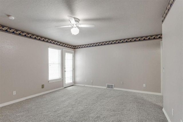 carpeted empty room featuring a textured ceiling and ceiling fan