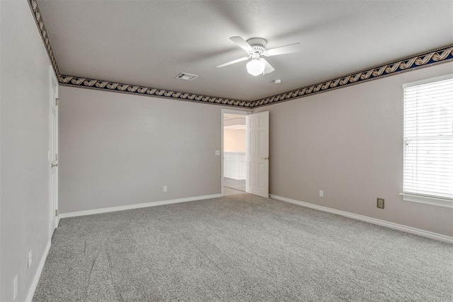 spare room featuring ceiling fan, a healthy amount of sunlight, and carpet