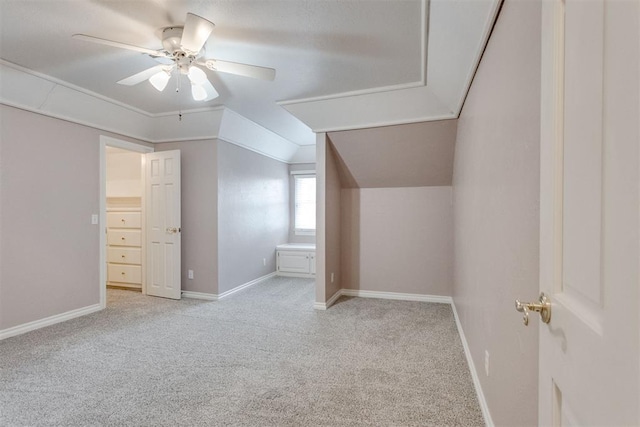 additional living space featuring lofted ceiling, light colored carpet, and ceiling fan