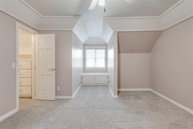 bonus room with light colored carpet and ceiling fan