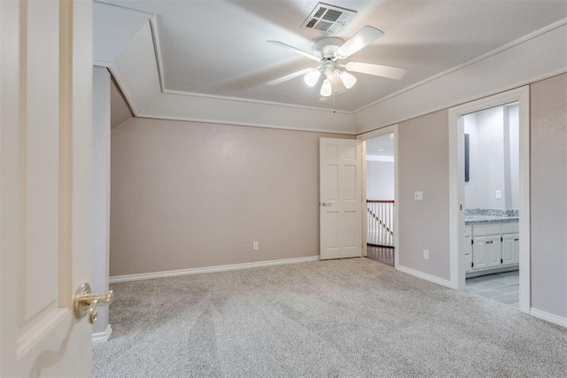 unfurnished bedroom featuring ceiling fan, light colored carpet, and connected bathroom