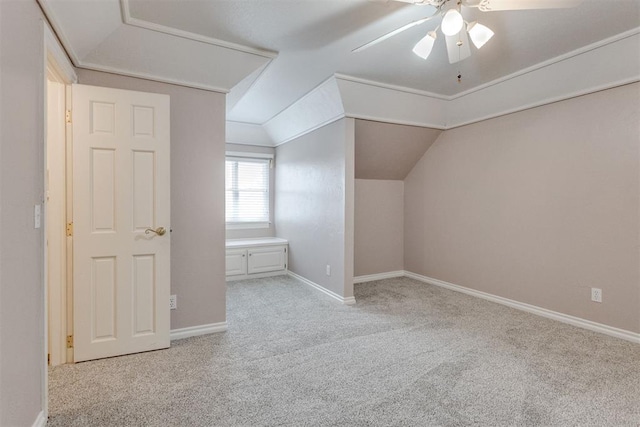 additional living space featuring vaulted ceiling, light colored carpet, and ceiling fan