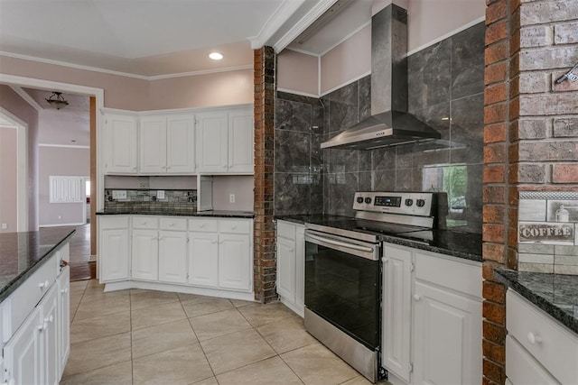 kitchen featuring white cabinetry, stainless steel electric stove, ornamental molding, and wall chimney exhaust hood