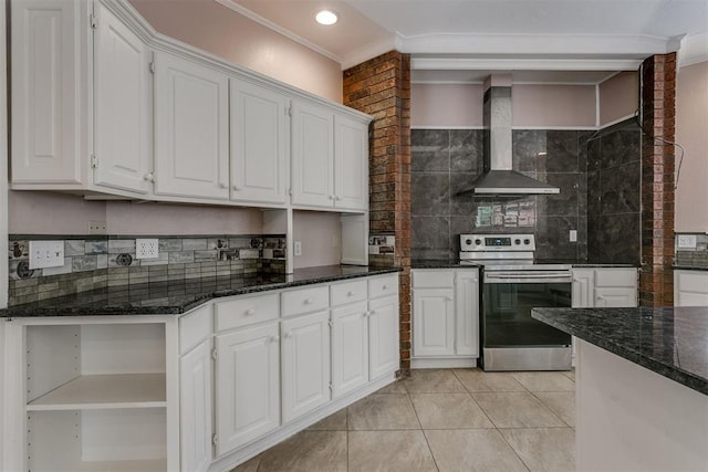 kitchen featuring white cabinetry, dark stone countertops, wall chimney exhaust hood, and electric stove