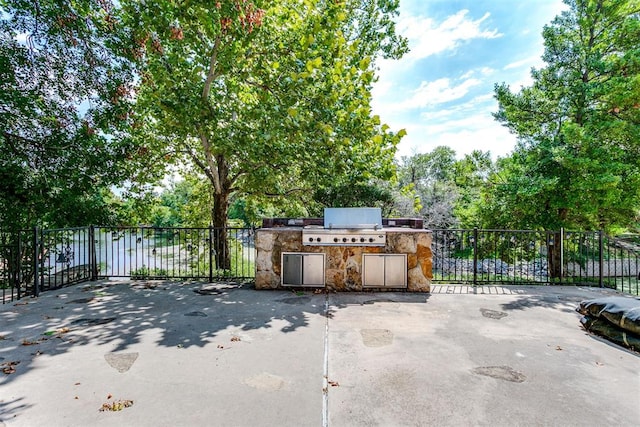 view of patio / terrace featuring an outdoor kitchen and a grill