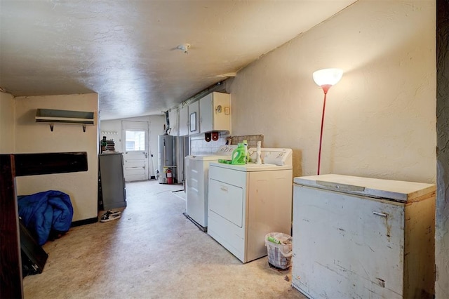 washroom with cabinets, washing machine and clothes dryer, and gas water heater