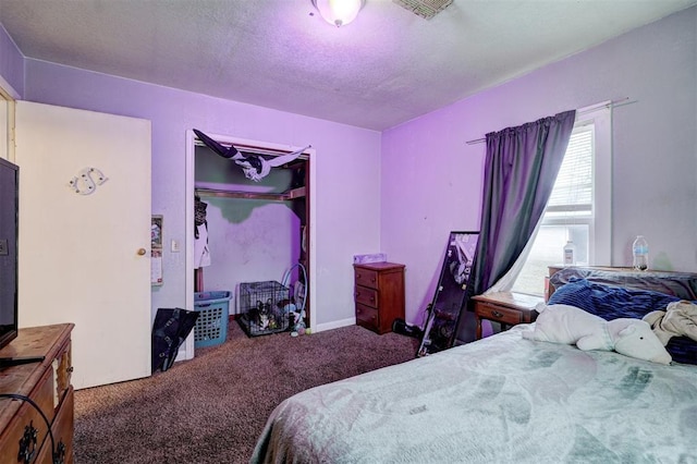 bedroom with carpet floors, a textured ceiling, and a closet