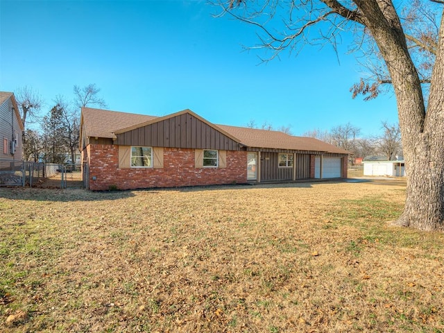 ranch-style house with a garage and a front lawn