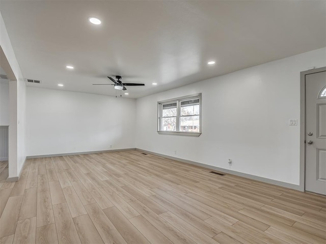 unfurnished living room featuring ceiling fan and light hardwood / wood-style floors