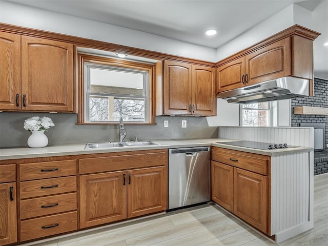 kitchen featuring tasteful backsplash, dishwasher, sink, black electric stovetop, and light hardwood / wood-style flooring