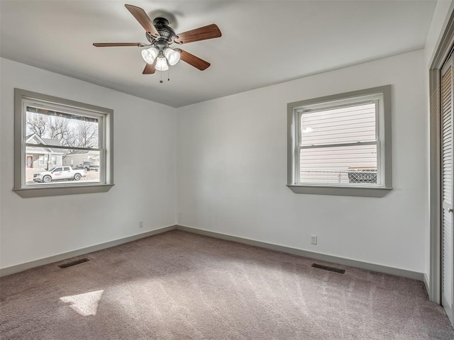 spare room with carpet floors and ceiling fan