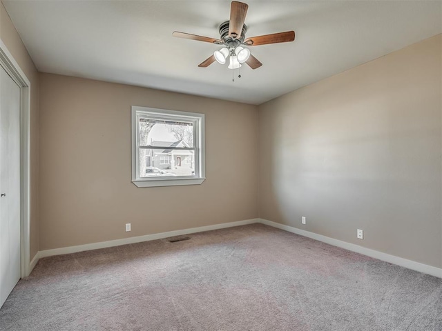 carpeted empty room with ceiling fan