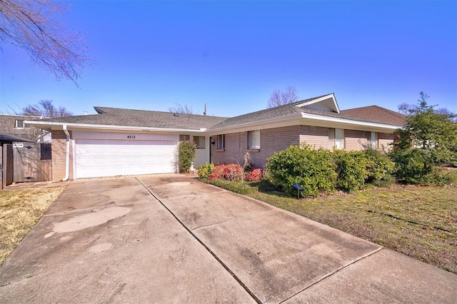 single story home with a garage and a front yard